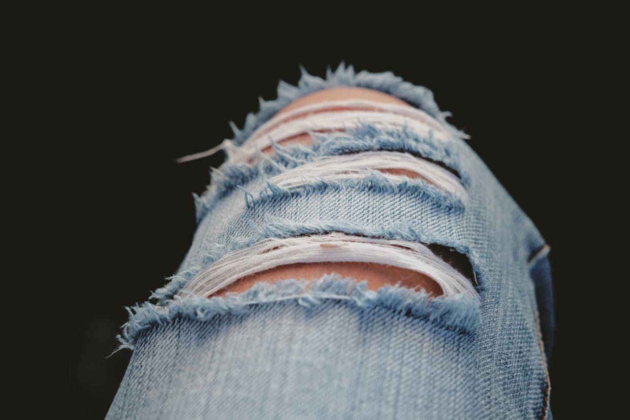 Detailed shot of torn denim jeans showcasing modern fashion and style.